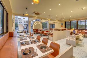 a dining room with tables and chairs in a restaurant at VITS Select Nashik in Nashik
