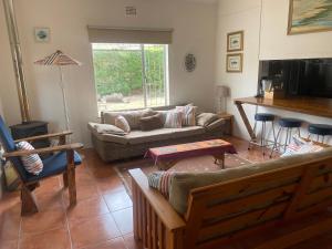 a living room with a couch and a table at lagoon value ! in Langebaan