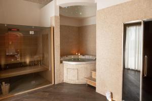 a bathroom with a tub in the corner of a room at Relais Il Santissimo in Turi