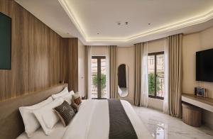 a bedroom with a large bed and a television at Luckin Hotel Lê Đức Thọ by Urban B in Ho Chi Minh City