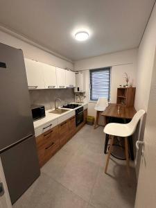 a kitchen with a refrigerator and a table in it at Two-room apartment in Dudu