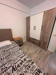a bedroom with a bed and cabinets in it at Two-room apartment in Dudu