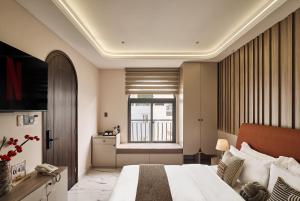 a hotel room with a bed and a window at Luckin Hotel Lê Đức Thọ by Urban B in Ho Chi Minh City