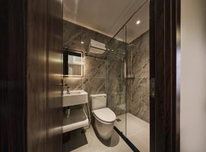 a bathroom with a toilet and a sink and a shower at Luckin Hotel Lê Đức Thọ by Urban B in Ho Chi Minh City