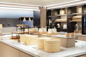 a store with a bunch of cheeses on a counter at JI Hotel Beijing Xizhimen in Beijing +30 photos