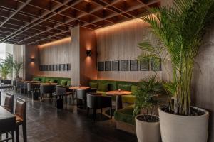 a restaurant with tables and chairs and plants at The Dali EDITION in Dali