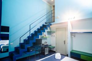 a blue staircase in a room with a bed at Correra 241 Lifestyle Hotel in Naples