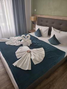 a bed with two white towels on it at VillaWie in Rheda-Wiedenbrück