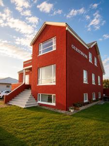 a red brick building with a sign on it at Grindavik Guesthouse self check in & out in Grindavík