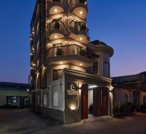 a tall building with a sign in front of it at Luckin Hotel Lê Đức Thọ by Urban B in Ho Chi Minh City