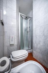 a bathroom with a toilet and a shower and a sink at Grand Hotel Panama Firenze in Florence +111 photos