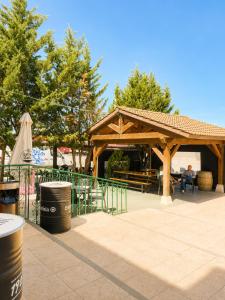 a wooden pavilion with a person sitting at a table at Hostal la Abuela in Simancas