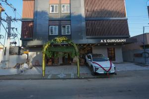 a car parked in front of a building at Hotel ASG Grand in Ranipet