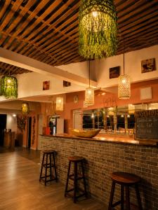a bar in a restaurant with two bar stools at The Sanctuary MADAGASCAR in Foulpointe