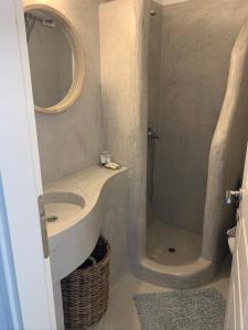 a bathroom with a sink and a shower at The Sunrise Villa in Koumáros +25 photos