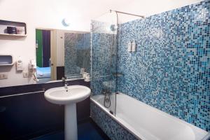 a bathroom with a sink and a shower and a tub at Correra 241 Lifestyle Hotel in Naples +95 photos