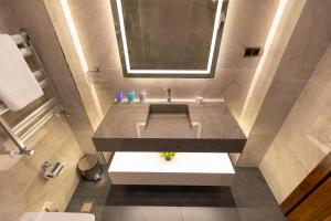 a bathroom with a sink and a mirror at SOI Hotel & Casino in Svilengrad