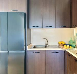 a kitchen with a stainless steel refrigerator and a sink at Canaryislandshost I Marino in Famara