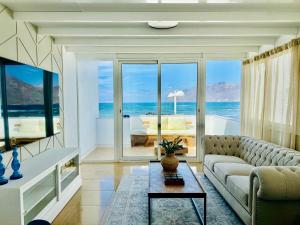 a living room with a couch and a table at Canaryislandshost I Marino in Famara