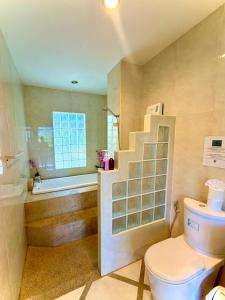 a bathroom with a toilet and a sink and a bath tub at Viking House Villa Deluxe in Ko Tao