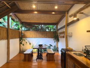 a kitchen with a table and benches and a sink at Yumi Villas in San Vicente