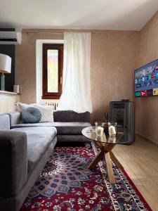 a living room with a couch and a coffee table at Siham lake home in Verceia