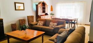 a living room with a couch and a table at Protea House in Graaff-Reinet