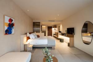 a bedroom with a white bed and a mirror at ARATO by E-GEO, Adults Only in Kos +186 photos