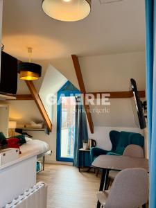 a room with a bed and a table and chairs at GC - Au Gré Du Vent in Wissant