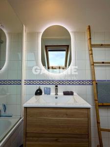 a bathroom with a sink and a mirror at GC - Au Gré Du Vent in Wissant +20 photos