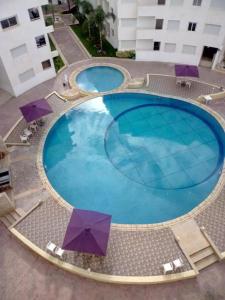 an overhead view of a large swimming pool with umbrellas at Escale BOUZNIKA Centre in Bouznika +23 photos