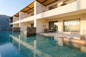a swimming pool in front of a house at ARATO by E-GEO, Adults Only in Kos