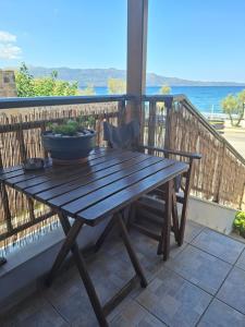 a wooden table with a bowl on it on a balcony at Blu Casa Del Mare in Monemvasia
