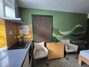 a kitchen with two chairs and a table and a counter at Morgenstond in Groesbeek