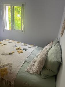 a bed in a room with a window at Forest Garden Retreat with Pool near the Beach in Seignosse +10 photos
