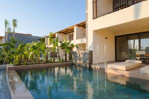 a swimming pool in front of a building at ARATO by E-GEO, Adults Only in Kos
