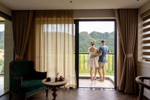 a man and a woman standing in front of a door at Hotel LaVue Tam Coc in Ninh Binh