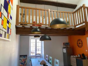 a kitchen with two pendant lights and a table at LA PASSIFLORE in Azé