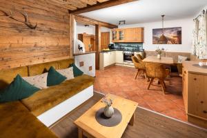 a living room and kitchen with a couch and a table at Ferienwohnung Roislerlehen in Bischofswiesen +31 photos