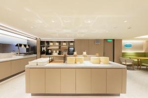 a large kitchen with a large island in a room at JI Hotel Beijing Xizhimen in Beijing