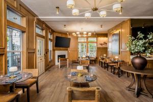 a dining room with tables and chairs and a tv at Polo House and Bungalows in Santa Ynez