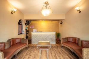 a waiting room with couches and a table at Treebo Sunshine Beach Resort with Swimming Pool in Calangute