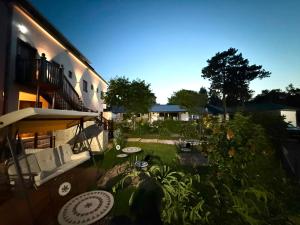 an outdoor patio with a couch and an umbrella at Pensiunea Miruna Valentin in Jupiter