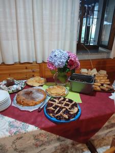 a table with pies and other food on it at LOCANDA Alla Paia in Pracul