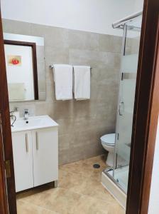 a bathroom with a white sink and a toilet at Casa Lotus in Aljezur +5 photos