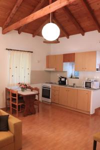 a kitchen with a table and a dining room at Summer Studios 2 in Koroni
