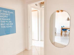 a hallway with a mirror and a dining room at Appartamento Donà 2 in Rovigo