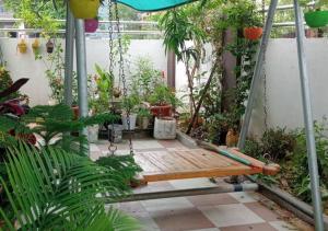 a swing in the middle of a garden at The Little Braj Homestay in Mathura