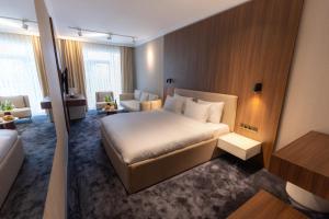 a hotel room with a bed and a couch at SOI Hotel & Casino in Svilengrad +34 photos
