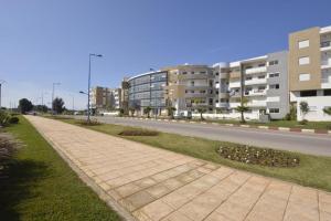 an empty street with buildings on the side of a road at Super Appartement à Bouznika in Bouznika